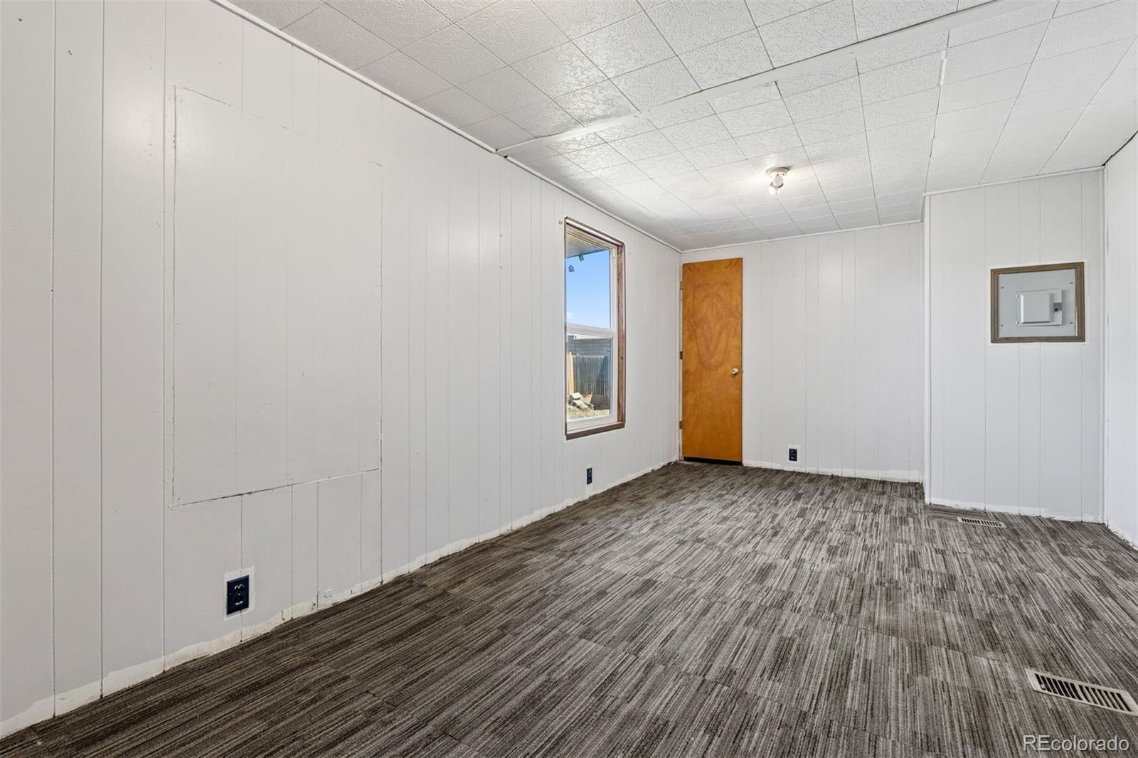 1044 Mac Davidson Circle Dacono, CO 80514 - Photo 12 of 25 a view of an empty room with wooden floor