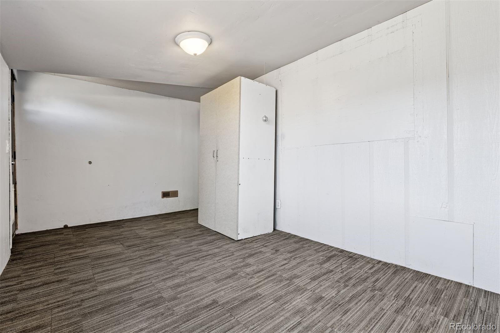 1044 Mac Davidson Circle Dacono, CO 80514 - Photo 16 of 25 a view of an empty room with wooden floor