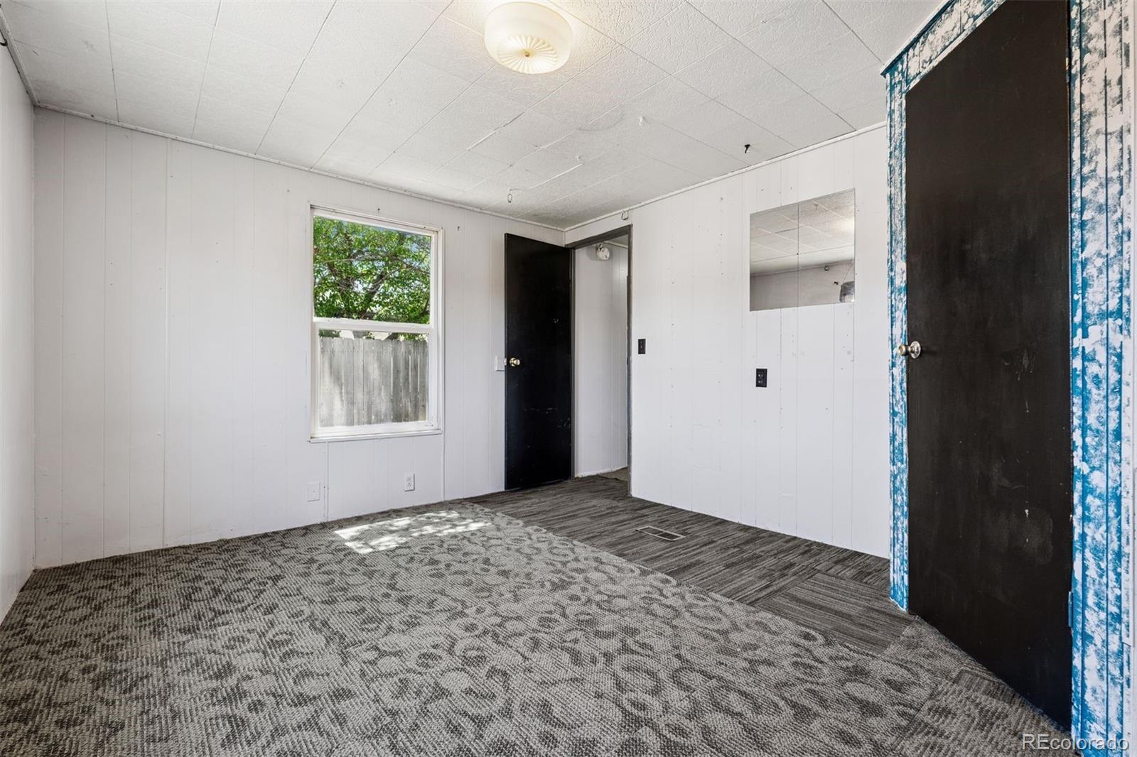 1044 Mac Davidson Circle Dacono, CO 80514 - Photo 17 of 25 a view of an empty room with a window