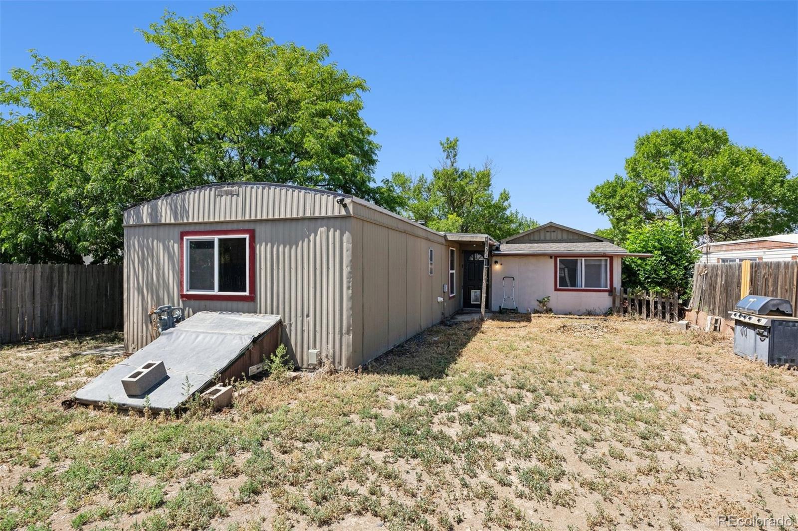 1044 Mac Davidson Circle Dacono, CO 80514 - Photo 20 of 25 a backyard of a house with table and chairs