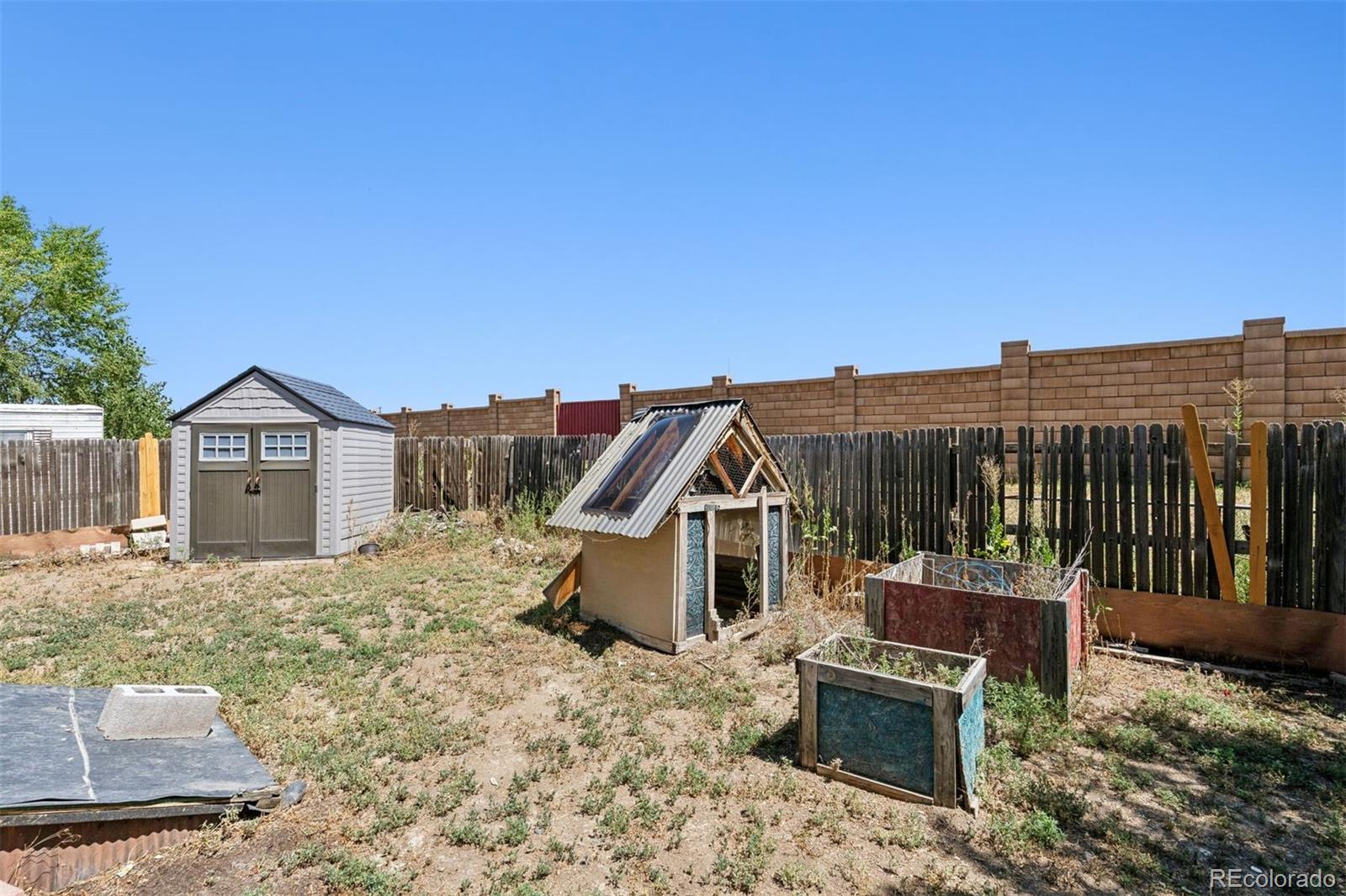 1044 Mac Davidson Circle Dacono, CO 80514 - Photo 24 of 25 a view of a house with a yard