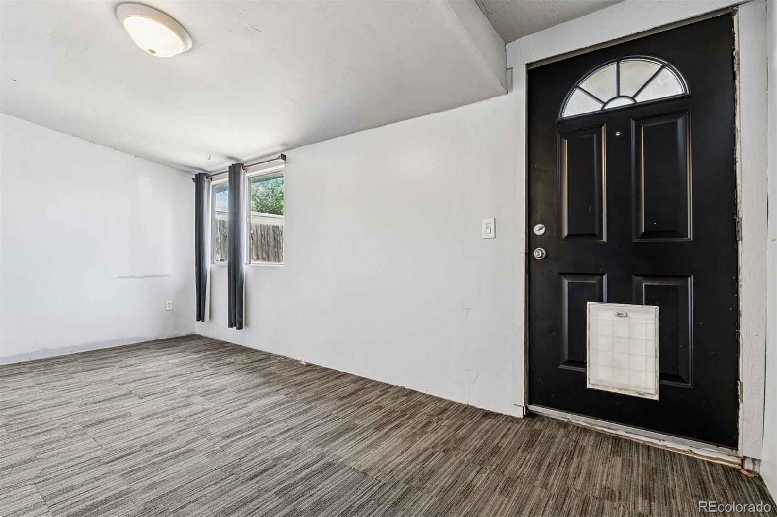 1044 Mac Davidson Circle Dacono, CO 80514 - Photo 7 of 25 a view of empty room with wooden floor and fan