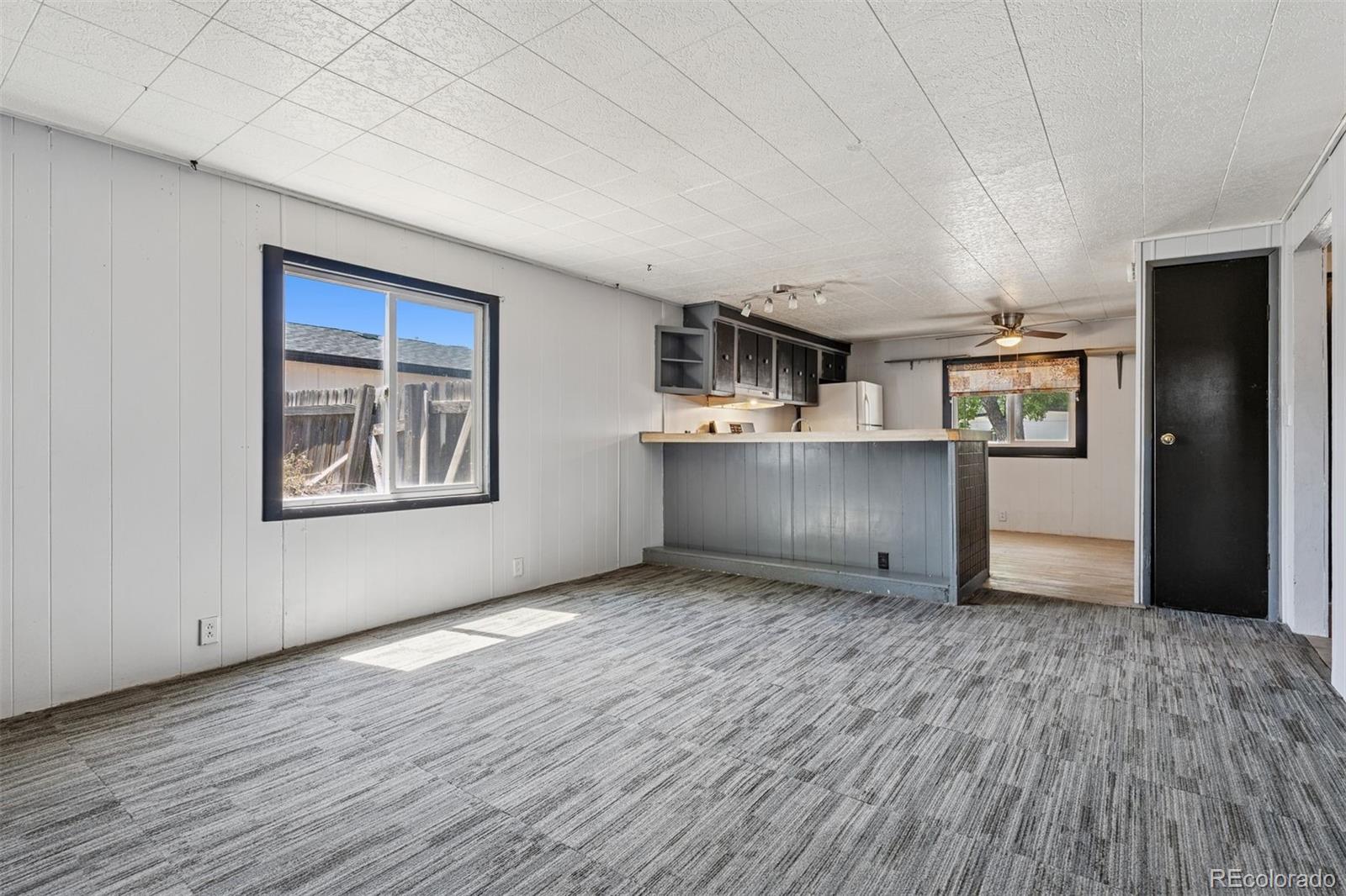 1044 Mac Davidson Circle Dacono, CO 80514 - Photo 9 of 25 a view of a kitchen with furniture and wooden floor