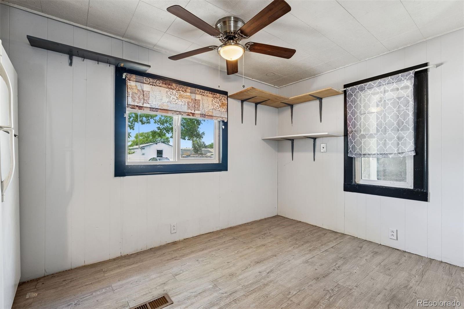 1044 Mac Davidson Circle Dacono, CO 80514 - Photo 10 of 25 wooden floor in an empty room with a window