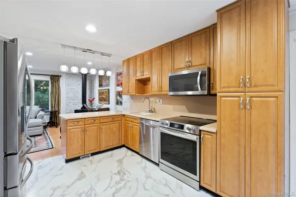 a kitchen with stainless steel appliances granite countertop a stove top oven a sink and a microwave
