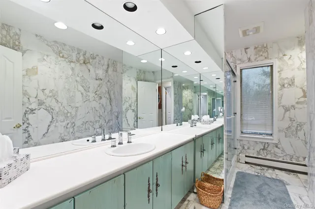 a bathroom with double vanity sinks and a large mirror