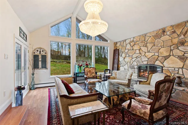 a living room with furniture a window and a chandelier