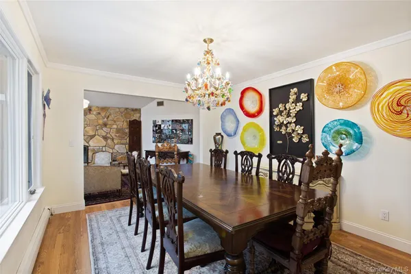 a dining room with furniture and chandelier