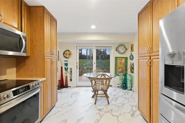 a kitchen with a refrigerator and a stove top oven