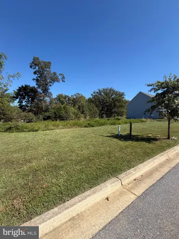 a view of a garden with a building in the background