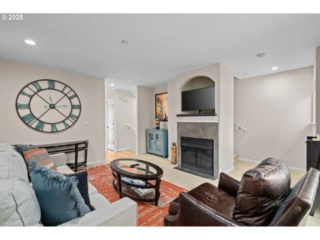 a living room with furniture a fireplace and a wall painting
