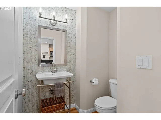 a bathroom with a toilet a sink and mirror
