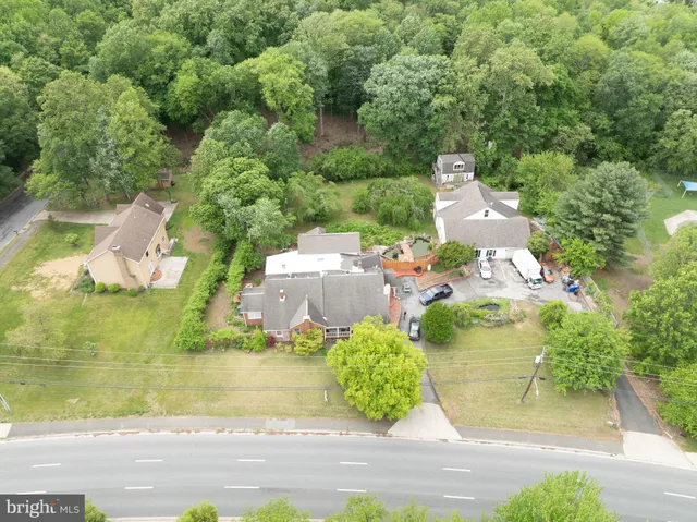 an aerial view of a house with a yard basket ball court