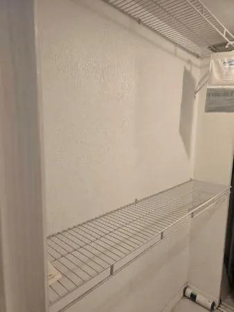 a kitchen with granite countertop a sink a stove and cabinets