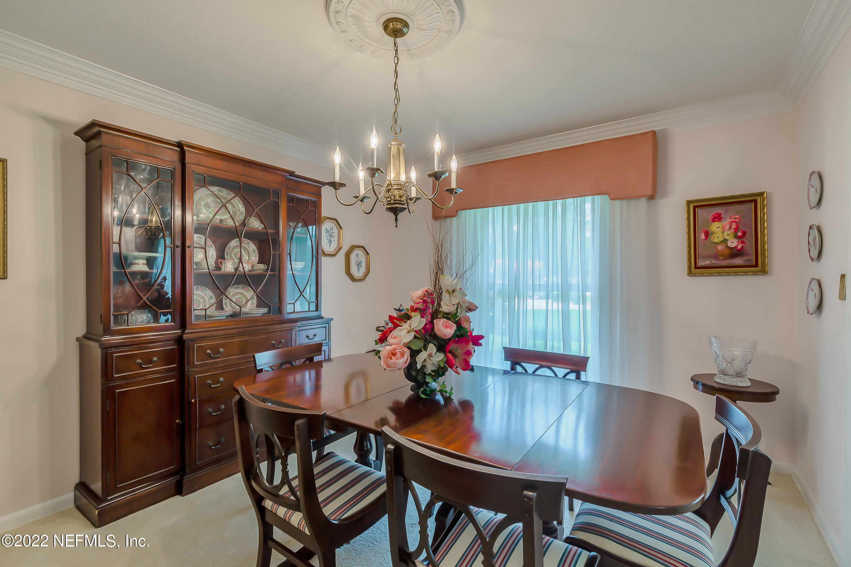 9475 Woodhaven Road Jacksonville, FL 32257 - Photo 18 of 78 a view of a dining room with furniture wooden floor and chandelier