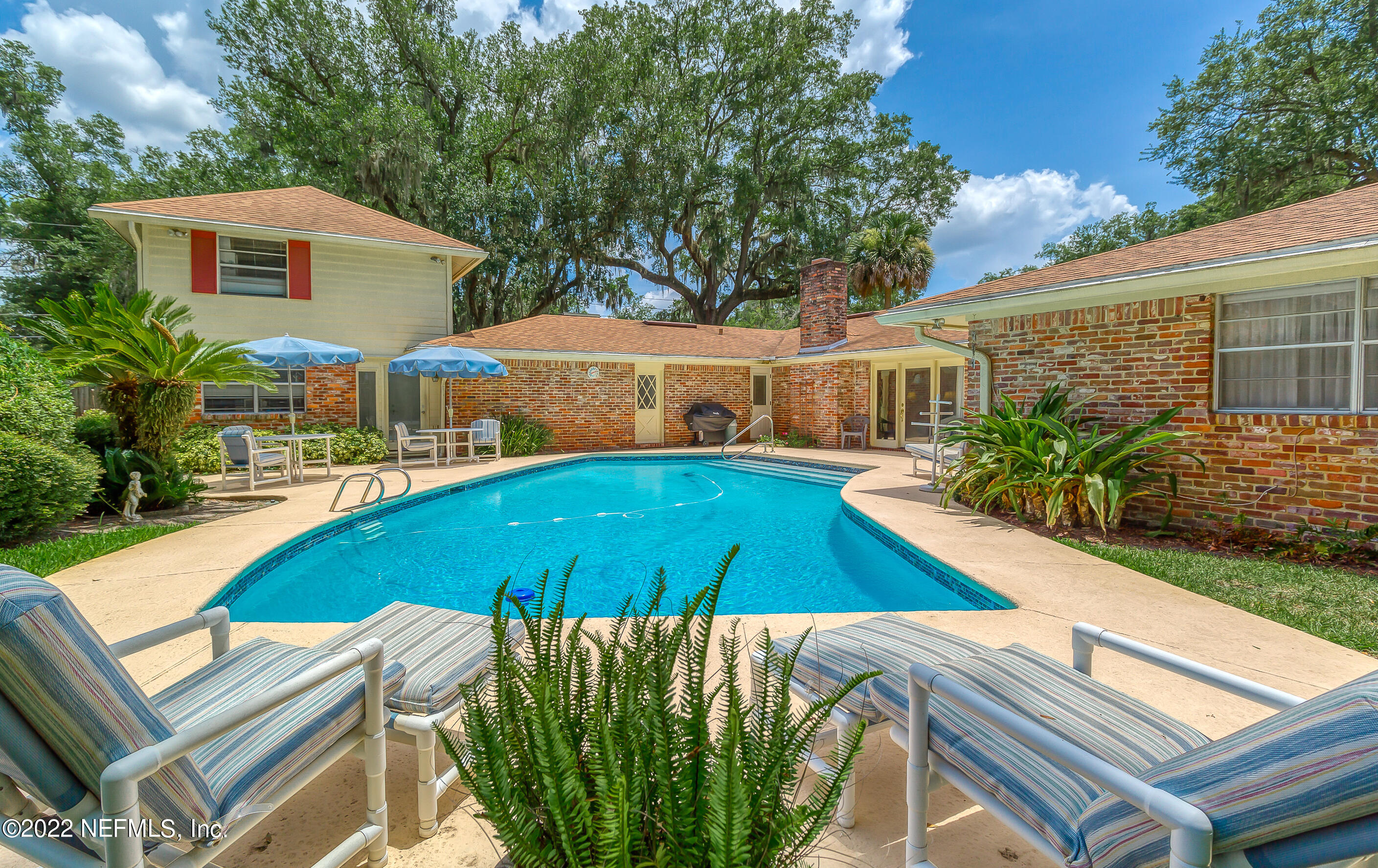 9475 Woodhaven Road Jacksonville, FL 32257 - Photo 2 of 78 a view of a house with swimming pool and sitting area