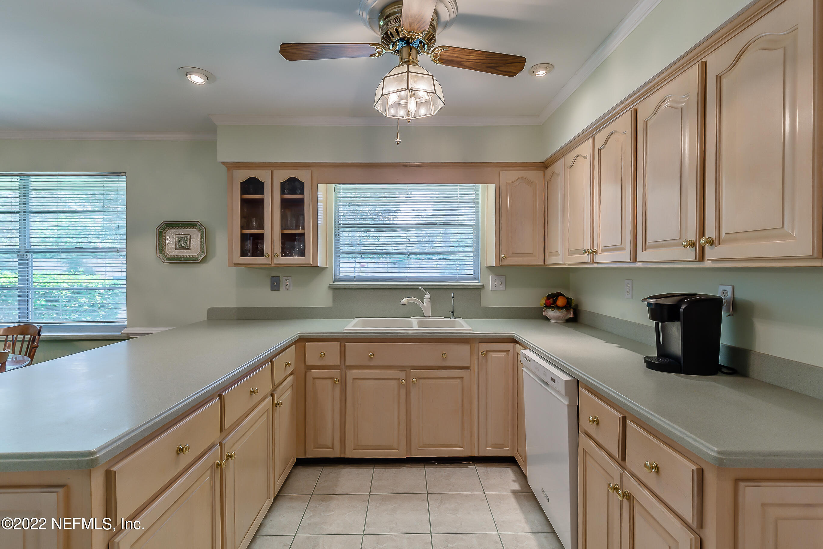 9475 Woodhaven Road Jacksonville, FL 32257 - Photo 21 of 78 a kitchen with a sink dishwasher a stove and white cabinets with wooden floor