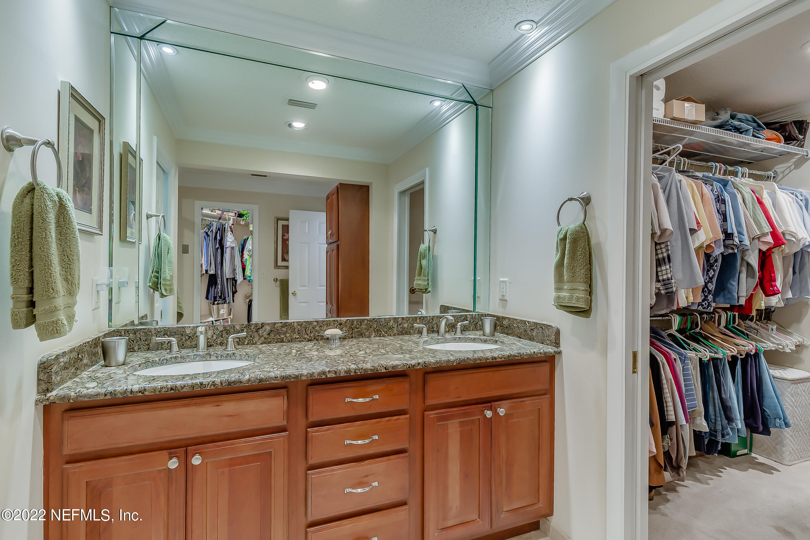 9475 Woodhaven Road Jacksonville, FL 32257 - Photo 46 of 78 a bathroom with a granite countertop sink and a mirror
