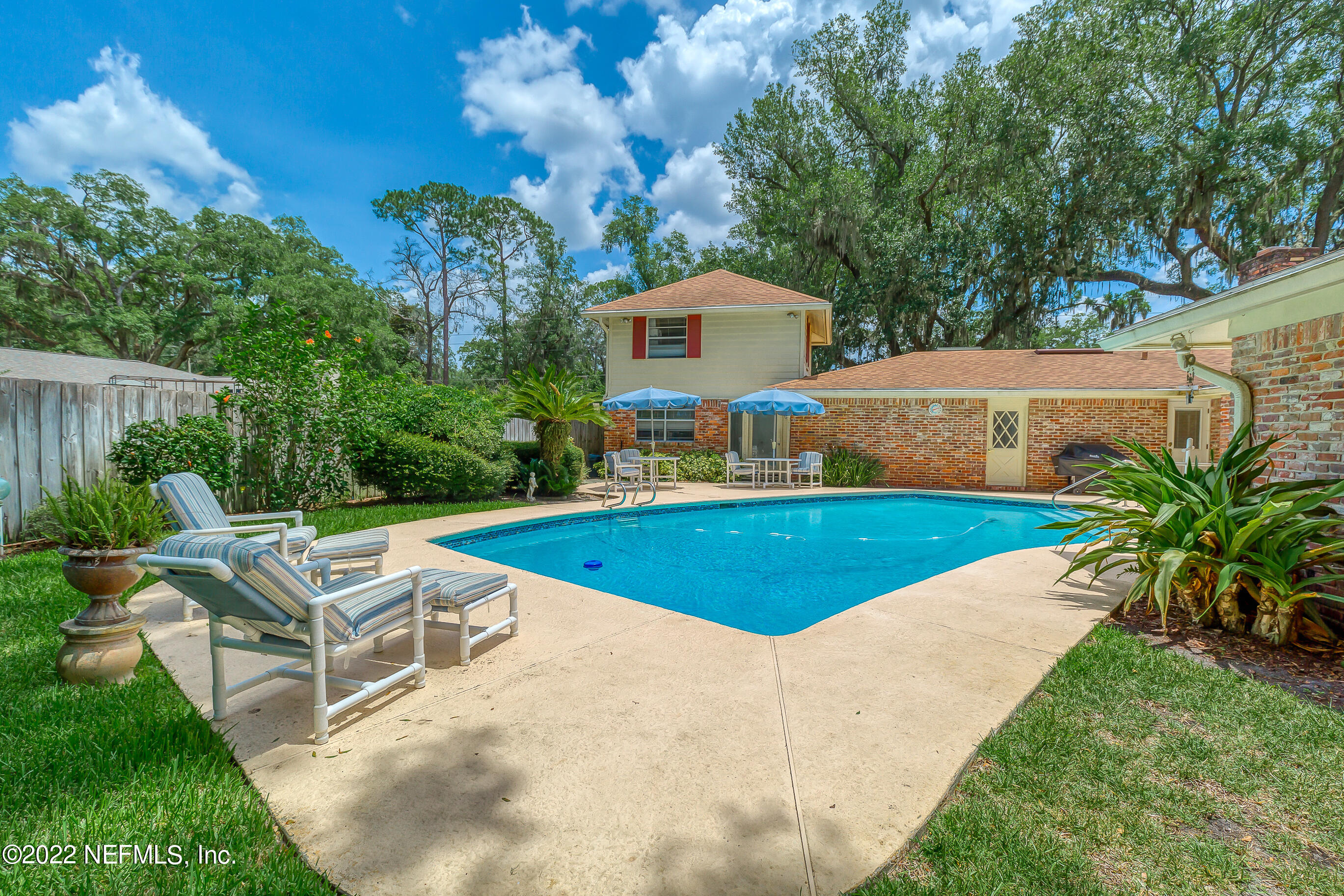 9475 Woodhaven Road Jacksonville, FL 32257 - Photo 54 of 78 a view of a house with pool and chairs