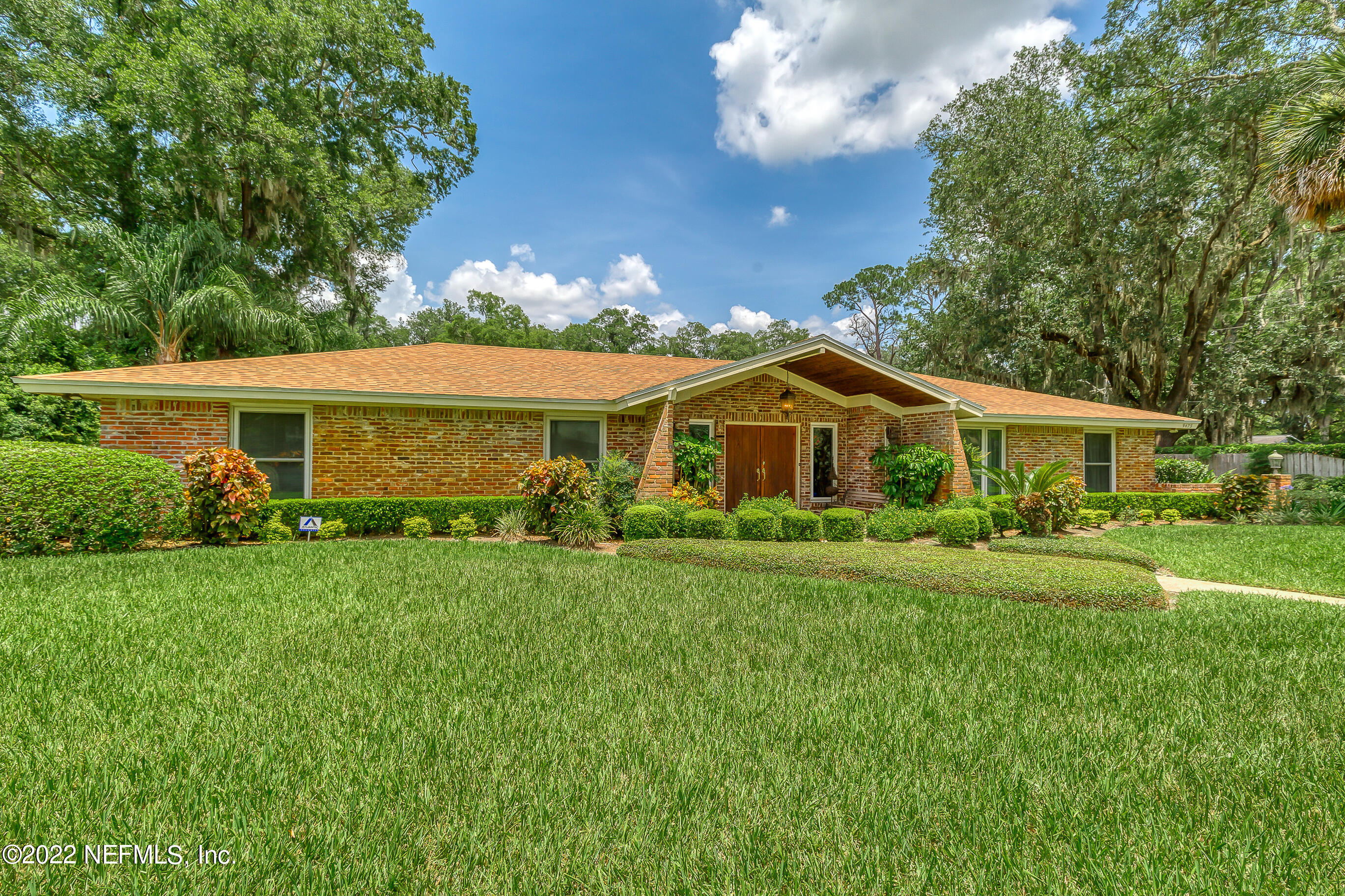 9475 Woodhaven Road Jacksonville, FL 32257 - Photo 63 of 78 a front view of a house with a yard and porch