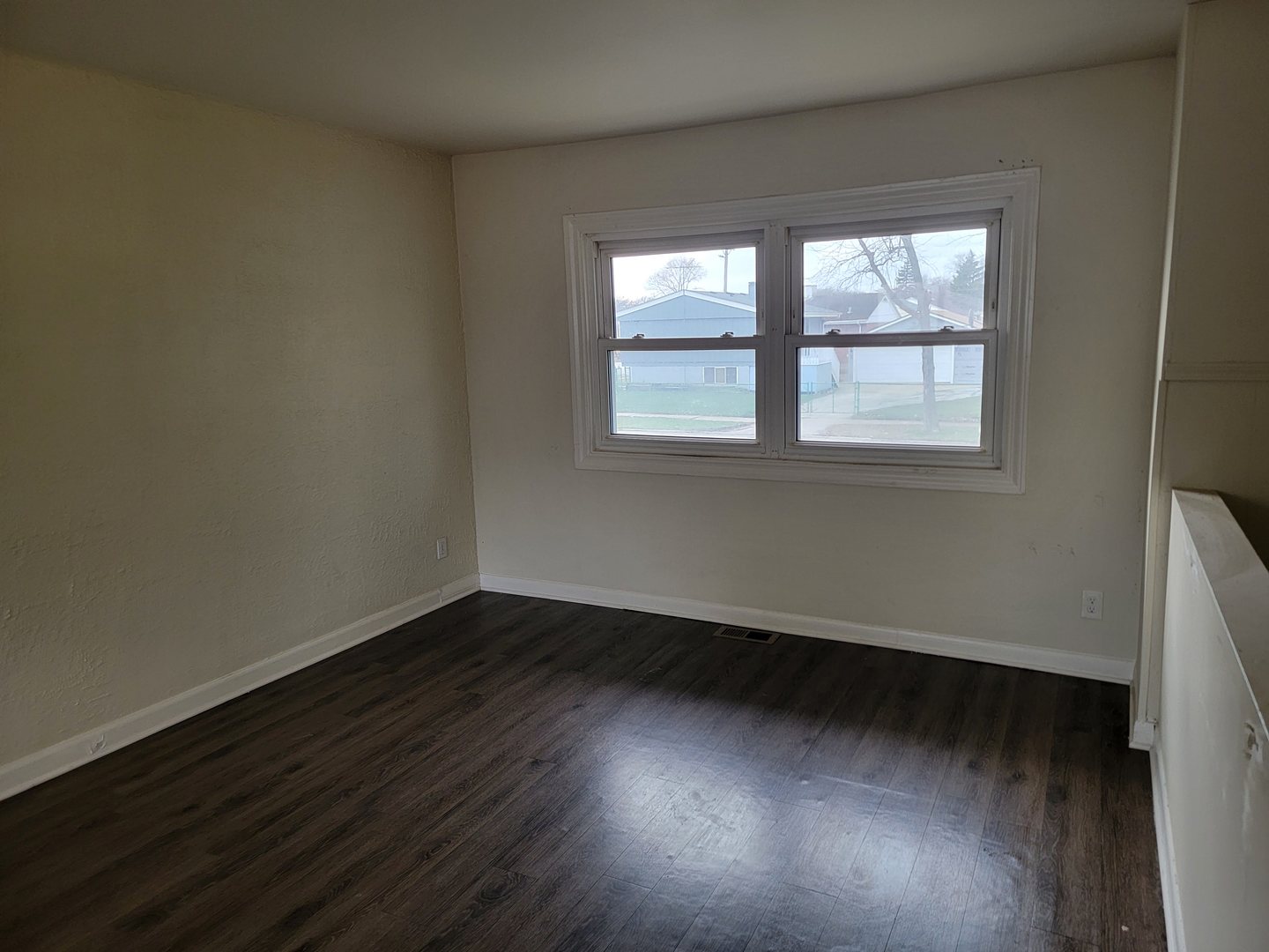 117 South Willow Lane Glenwood, IL 60425 - Photo 8 of 27 an empty room with wooden floor and windows