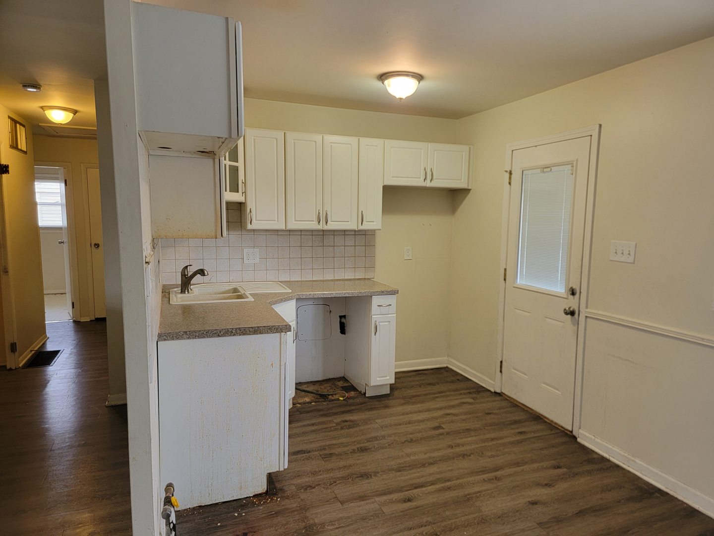 117 South Willow Lane Glenwood, IL 60425 - Photo 10 of 27 a kitchen with a sink stainless steel appliances wooden floor and cabinets