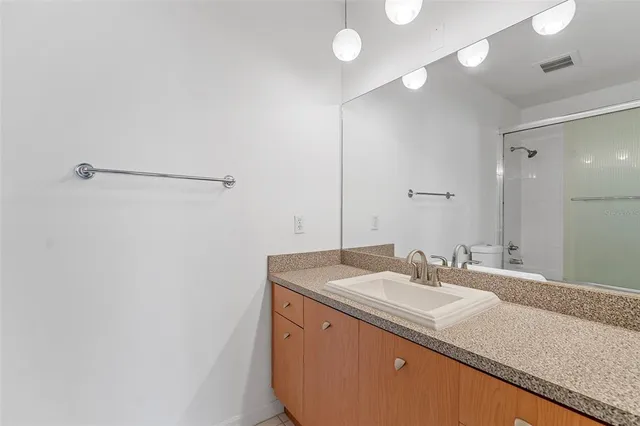 a bathroom with a sink a vanity and a mirror