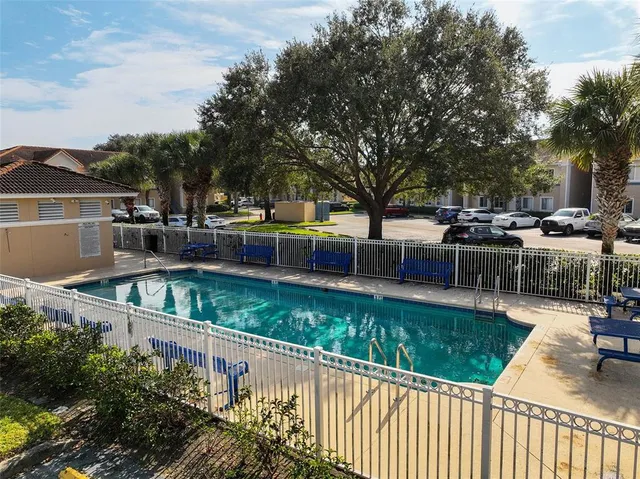 a view of a swimming pool with a patio and a garden