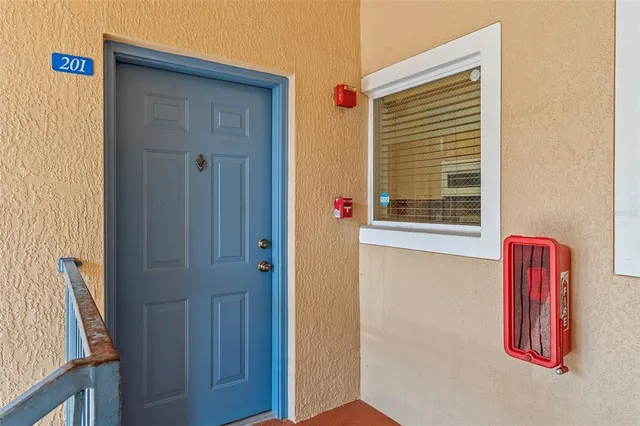 a view of front door with wooden door