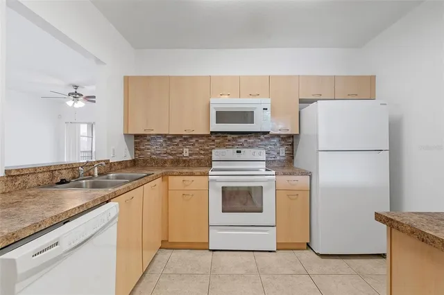 a kitchen with a sink stove and refrigerator