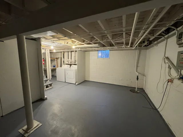 a view of empty room with wooden floor and windows