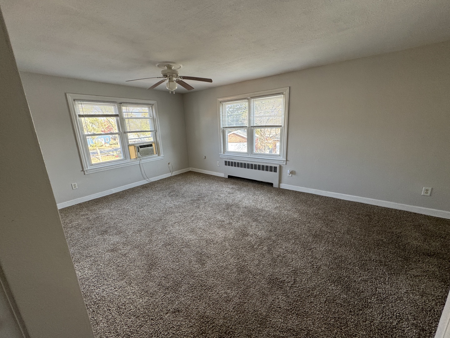 1111 Lincoln Street, Unit 2 Lockport, IL 60441 - Photo 5 of 23 an empty room with a window and a ceiling fan
