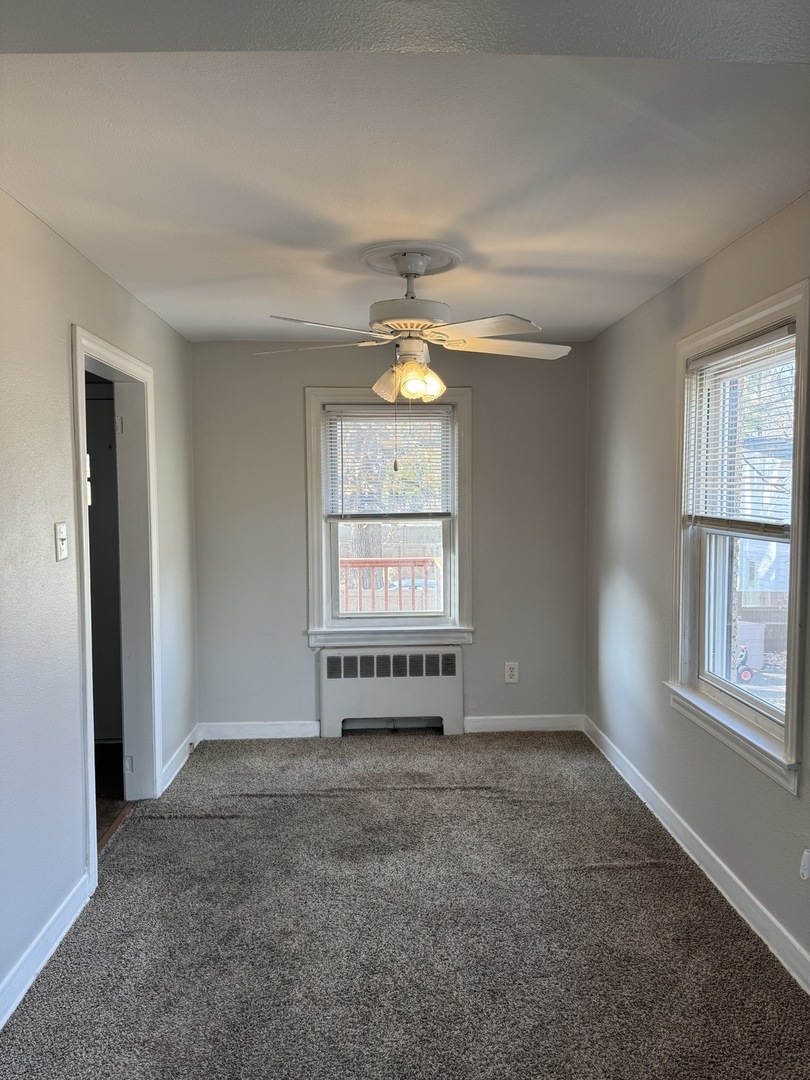 1111 Lincoln Street, Unit 2 Lockport, IL 60441 - Photo 8 of 23 an empty room with windows and fan