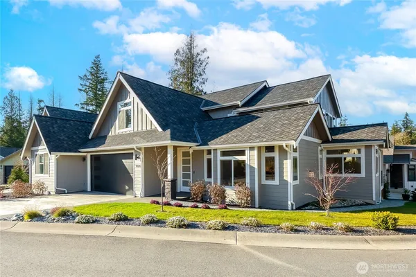 a view of a house with a swimming pool and a yard