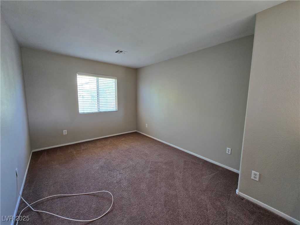 9560 Parker Springs Court Las Vegas, NV 89166 - Photo 18 of 37 Unfurnished room featuring dark colored carpet and baseboards