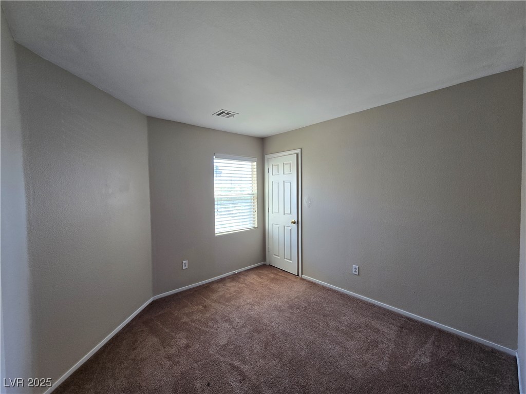 9560 Parker Springs Court Las Vegas, NV 89166 - Photo 26 of 37 Carpeted spare room featuring baseboards