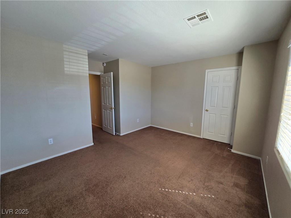 9560 Parker Springs Court Las Vegas, NV 89166 - Photo 30 of 37 Unfurnished room featuring dark colored carpet and baseboards