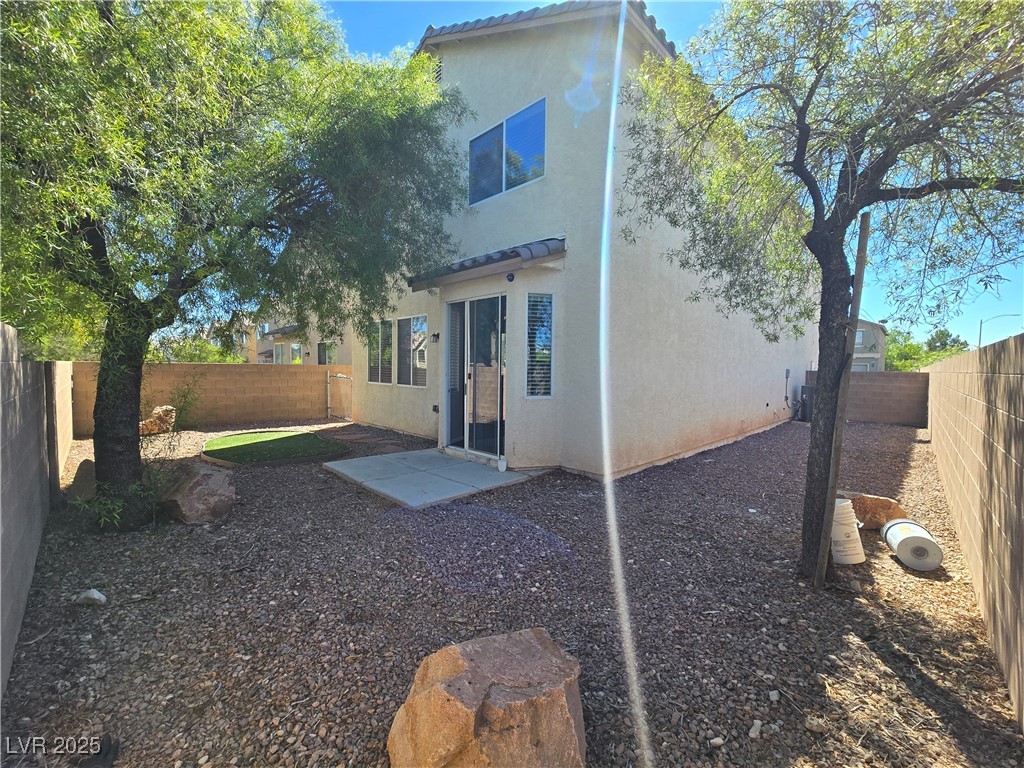 9560 Parker Springs Court Las Vegas, NV 89166 - Photo 34 of 37 Back of house featuring a fenced backyard, stucco siding, and a tile roof
