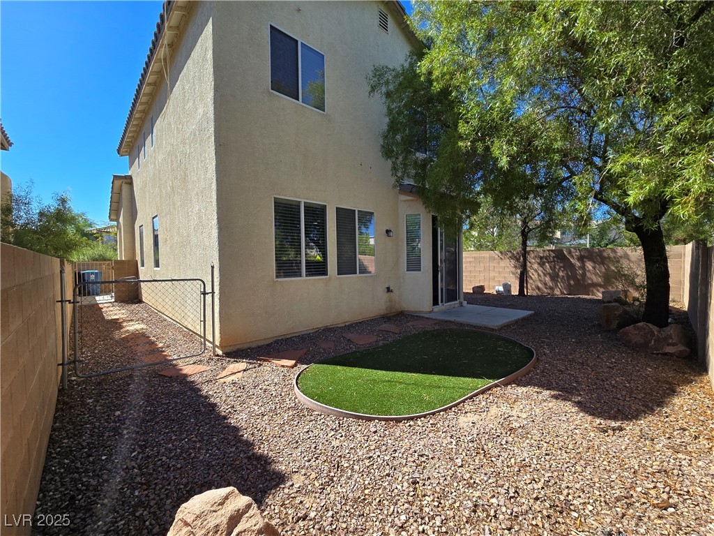 9560 Parker Springs Court Las Vegas, NV 89166 - Photo 35 of 37 Back of house featuring a patio, a fenced backyard, and stucco siding