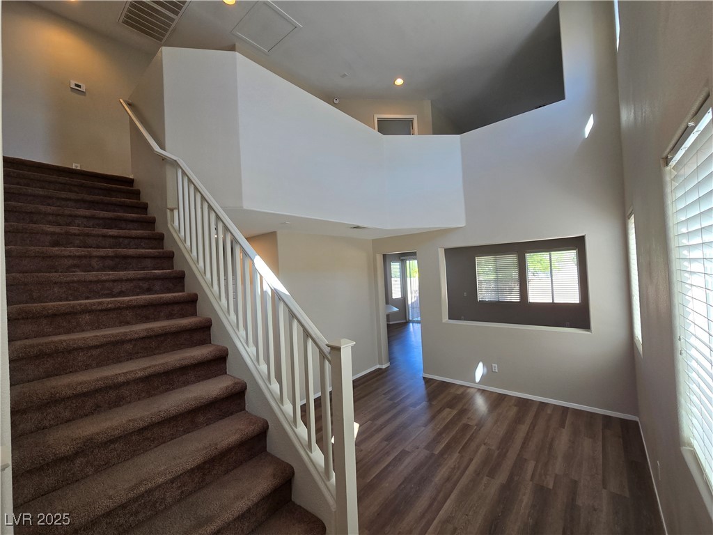 9560 Parker Springs Court Las Vegas, NV 89166 - Photo 4 of 37 Stairway featuring wood finished floors, a towering ceiling, and recessed lighting