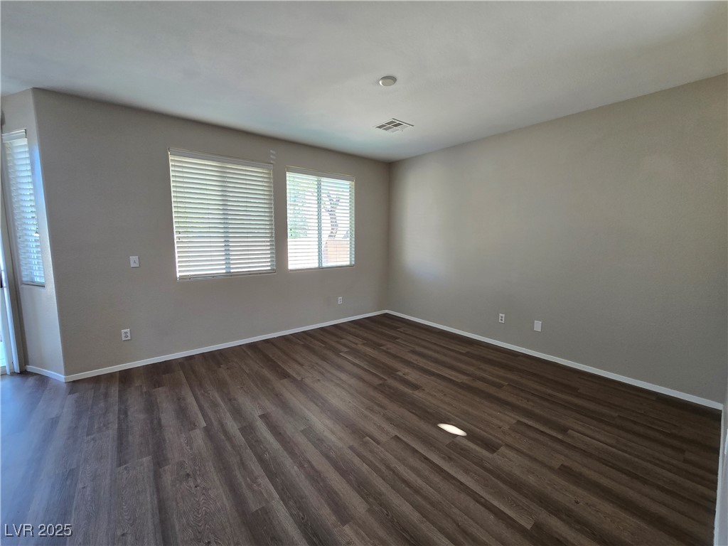 9560 Parker Springs Court Las Vegas, NV 89166 - Photo 9 of 37 Spare room featuring dark wood-style flooring
