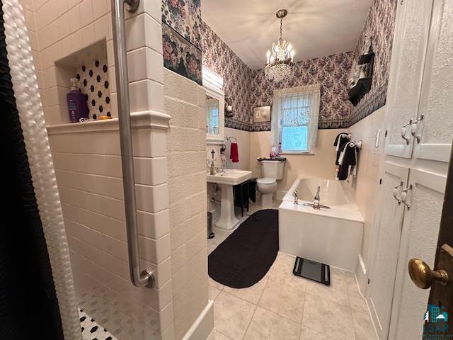 1601 4th Avenue International Falls, MN 56649 - Photo 19 of 50 Bathroom with wallpapered walls, toilet, a shower stall, a chandelier, and tile patterned flooring