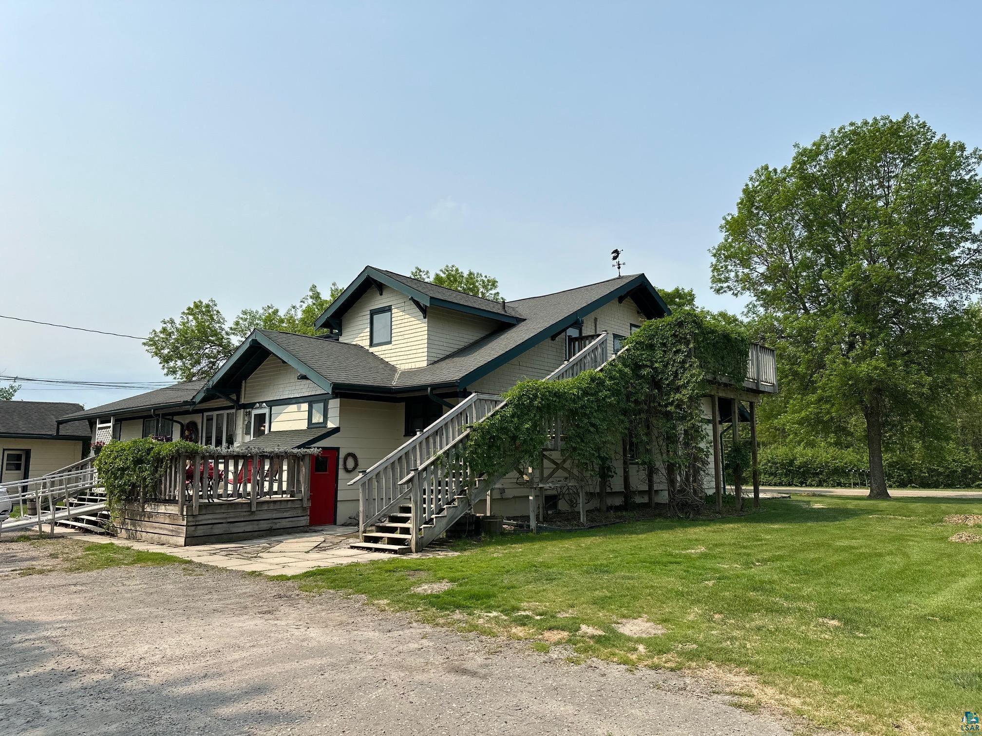 1601 4th Avenue International Falls, MN 56649 - Photo 24 of 50 View of front of property featuring a front lawn, stairs, and a shingled roof
