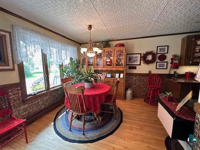 1601 4th Avenue International Falls, MN 56649 - Photo 5 of 50 Dining area with light wood-type flooring, ornamental molding, and a chandelier