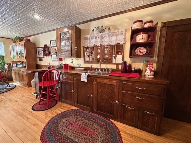 1601 4th Avenue International Falls, MN 56649 - Photo 9 of 50 Bar with an ornate ceiling, light wood finished floors, crown molding, and a sink