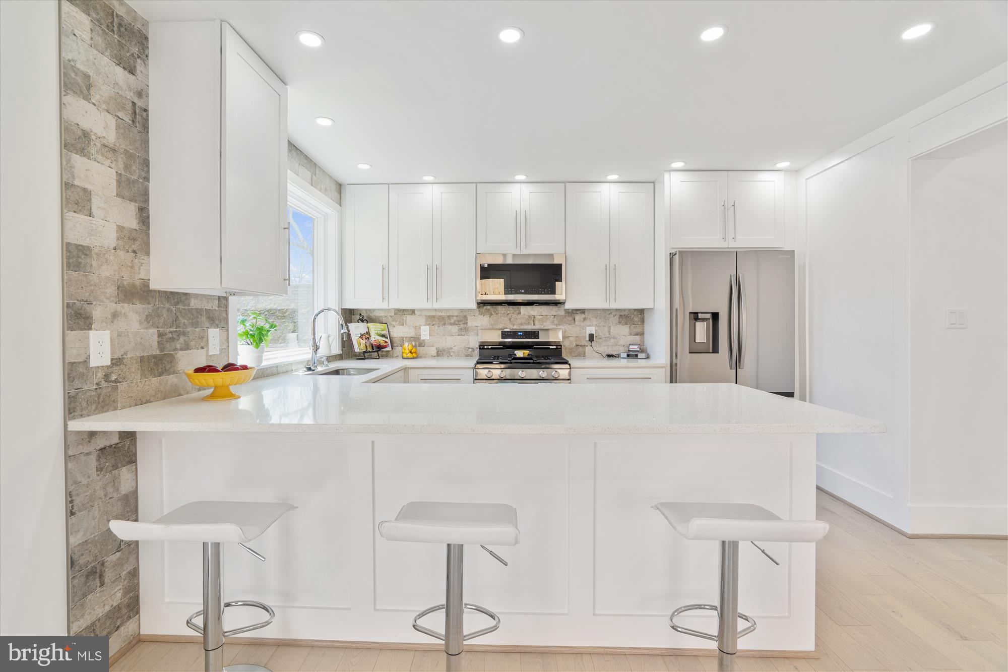 10011 Sidney Road Silver Spring, MD 20901 - Photo 11 of 35 a white kitchen with stainless steel appliances granite countertop a refrigerator and a stove top oven