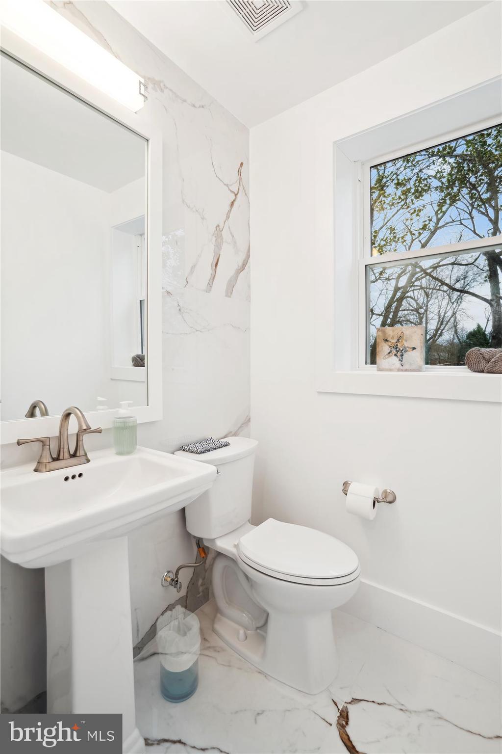 10011 Sidney Road Silver Spring, MD 20901 - Photo 18 of 35 a bathroom with a sink toilet and a mirror