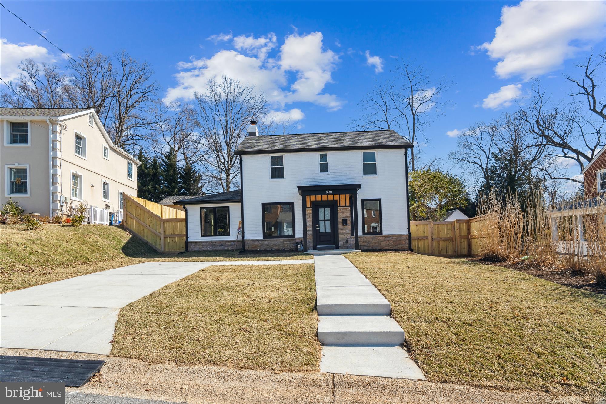 10011 Sidney Road Silver Spring, MD 20901 - Photo 2 of 35 a front view of a house with a yard and garage