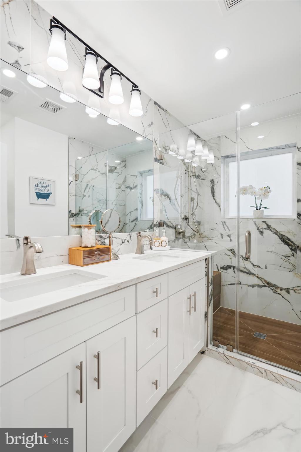 10011 Sidney Road Silver Spring, MD 20901 - Photo 22 of 35 a bathroom with a sink double vanity and a mirror