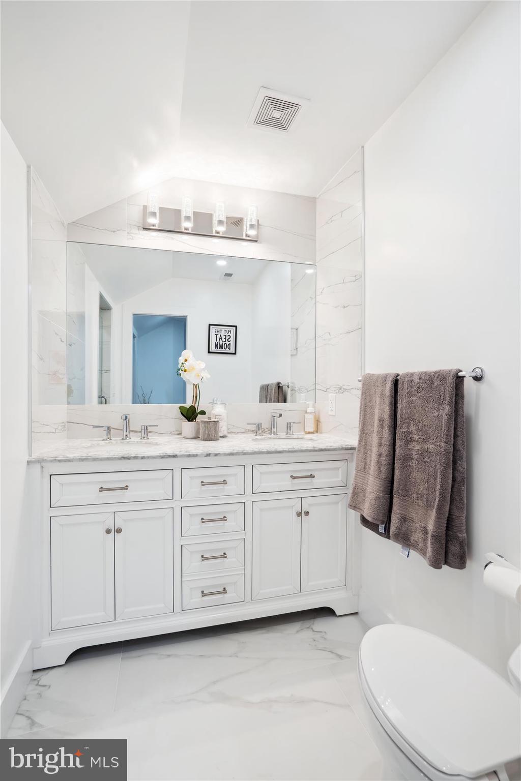 10011 Sidney Road Silver Spring, MD 20901 - Photo 28 of 35 a spacious bathroom with a double vanity sink and a mirror